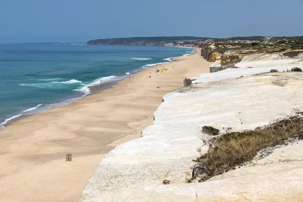 Long sandy beach and white cliffs at Praia d’El Rey