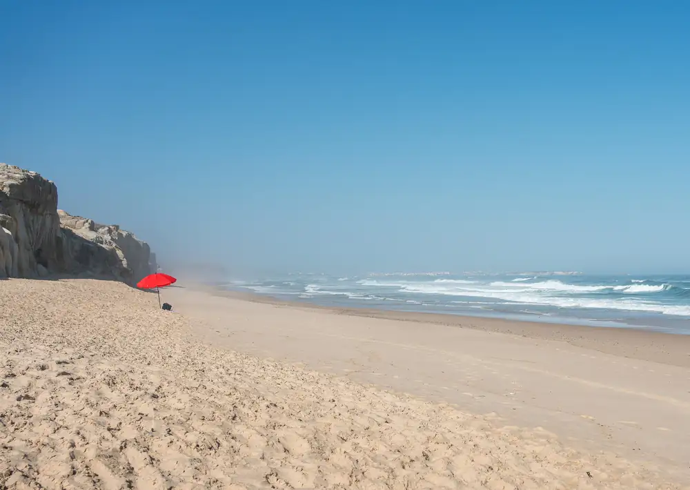 Red umbrella on the beach at Praia d’El Rey