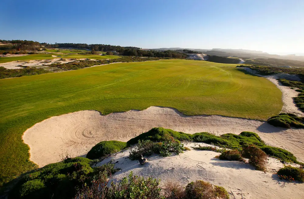 Green framed by dune bunkers at West Cliffs